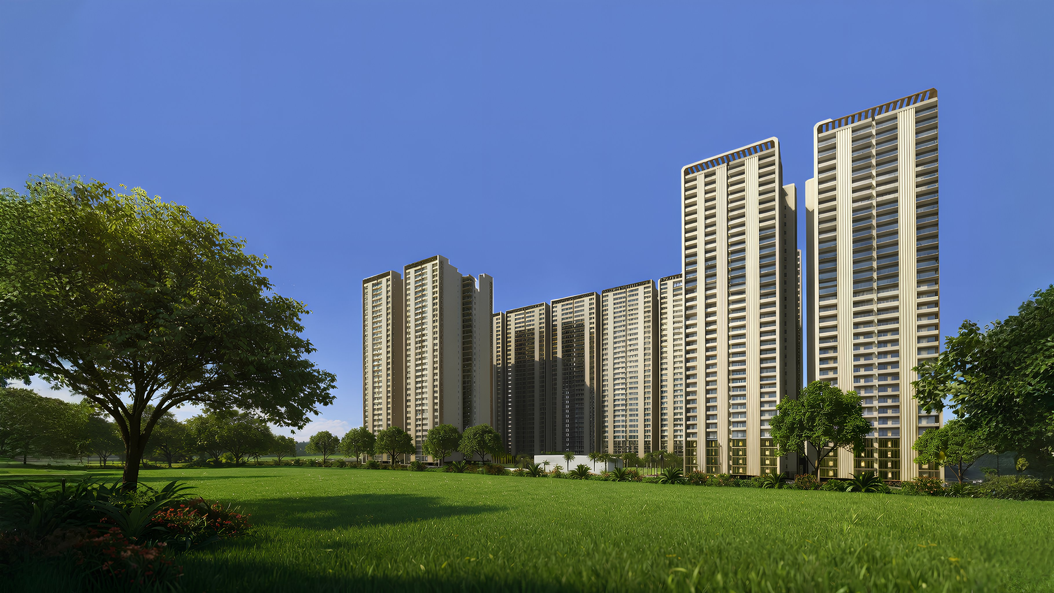 Forbes Fab Luxe Residences towers rising from landscaped green field under bright daylight with blue sky